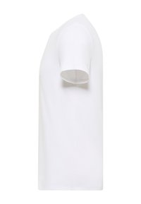 T-shirt blanc uni à manches courtes et col rond, vu de profil sur fond blanc.