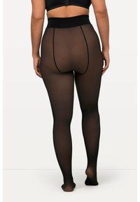 Collants noirs transparents avec une taille haute, présentant une texture lisse et des coutures contrastantes à l'arrière pour un détail supplémentaire.
