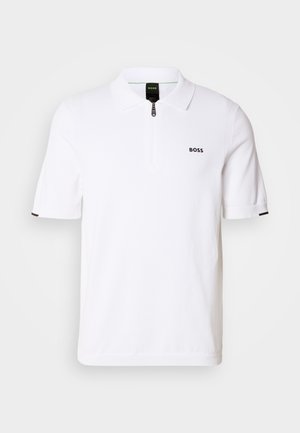 Bijela polo majica kratkih rukava od pletiva, s ovratnikom na zatvarač, jednobojna, s crnim logotipom na prsima. S rukavima s naglaskom.