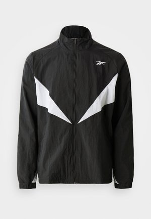 Black windbreaker jacket made from textured fabric. Features white angular accents and a high collar. Zipper closure and elastic cuffs.