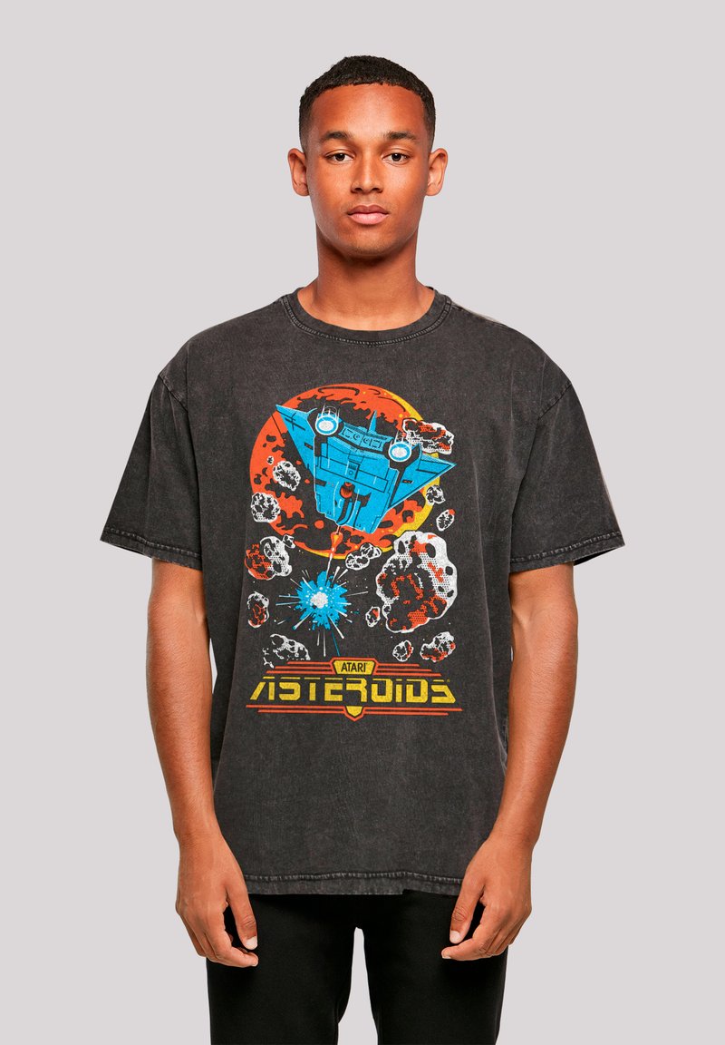 Black oversized t-shirt featuring a colorful graphic print of a spaceship, asteroids, and "Atari Asteroids" lettering.