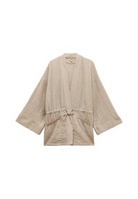 Beige kevyt kimono-tyylinen viitta, jossa on leveät hihat, kerätty vyötärö ja edessä solmittava nauha. Teksturoitu kangas, jossa on hienoja ryppyjä, ja sivutaskut.