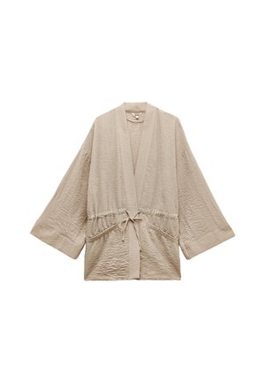 Beige kevyt kimono-tyylinen viitta, jossa on leveät hihat, kerätty vyötärö ja edessä solmittava nauha. Teksturoitu kangas, jossa on hienoja ryppyjä, ja sivutaskut.