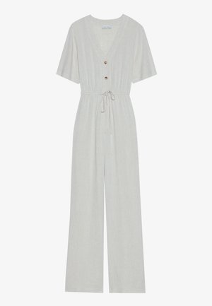 Jumpsuit beige clair en lin avec un décolleté en V, des manches courtes, une taille à cordon et deux détails de bouton à l'avant.
