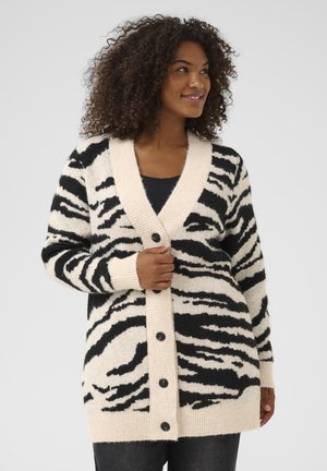 Schwarz-creme gestreifter Cardigan im Zebra-Stil, aus weichem Strickmaterial, mit tiefem V-Ausschnitt, gerippten Bündchen und fünf vorderen Knöpfen.