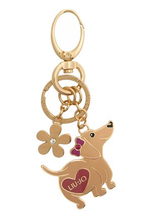 Portachiavi dorato con un charm a forma di bassotto con un cuore rosa, un charm a forma di fiore con uno strass e anelli intrecciati.