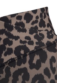 Leggings con un motivo a stampa leopardo marrone e nero, realizzati in un tessuto a coste. Dettagli di cuciture piatte lungo la cintura.