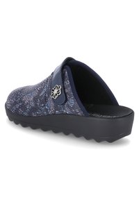 Dark blue slip-on clog with floral pattern, textured upper, and a smooth black sole featuring a subtle wave design. Silver flower accent on strap.