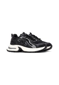 Zapatillas deportivas negras con una mezcla de malla y cuero sintético. Presentan una suela intermedia blanca gruesa, parte superior texturizada y un logo prominente.