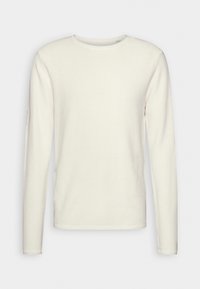 Kremowa bluzka z długim rękawem wykonana z fakturowanej tkaniny, z okrągłym dekoltem i prostym krojem. Nie posiada widocznych elementów metalowych ani wzorów.
