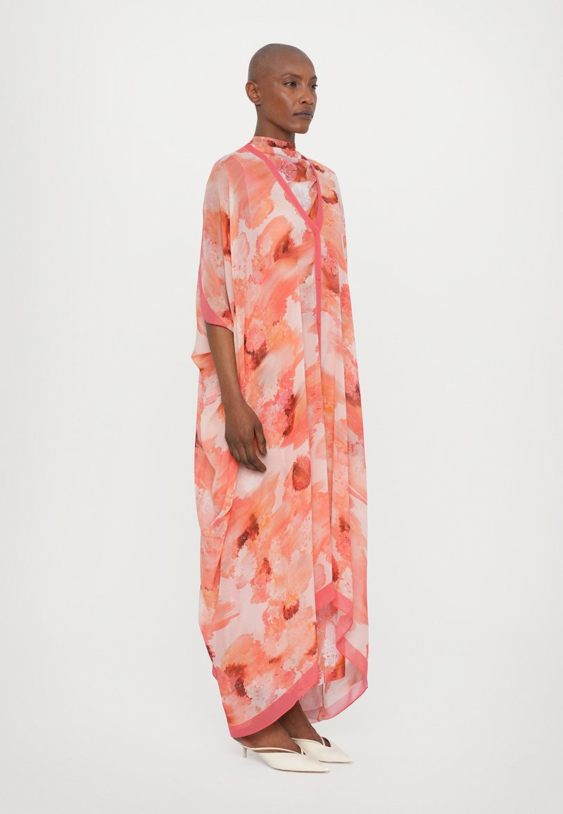 rodebjer orange dress Rodebjer Mabel dress is a coveted style for day and night, it features a shawl collar and a long, versatile belt for multiple styling options #wrap dress #kimonodress #persimmon #widesleeves #sideslits @rodebjerofficial #