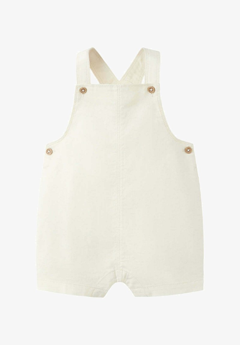 Combinaison pour bébé couleur crème avec bretelles croisées et boutons en bois sur les côtés et à l'avant.