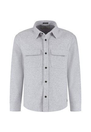 Lysegrå flanellskjorte med knapp-idet krage, to brystlommer og svarte knapper. Har lange ermer og rett kant.