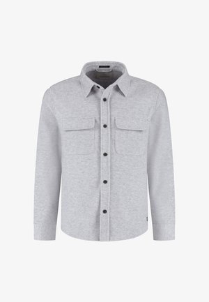 Lysegrå flanellskjorte med knapp-idet krage, to brystlommer og svarte knapper. Har lange ermer og rett kant.