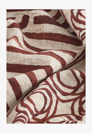 Fabric with a beige background featuring bold, dark red abstract circular and striped patterns. Soft texture with a woven appearance.