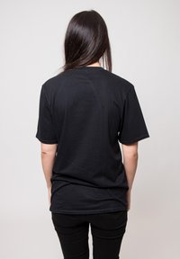Black short-sleeve t-shirt made of cotton with a crew neck, smooth texture, and a relaxed fit, designed for casual wear.