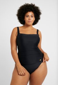 Biquíni preto com decote quadrado, detalhes texturizados ao longo do busto e franzido nas laterais. Logotipo dourado em destaque no quadril. Alças ajustáveis.