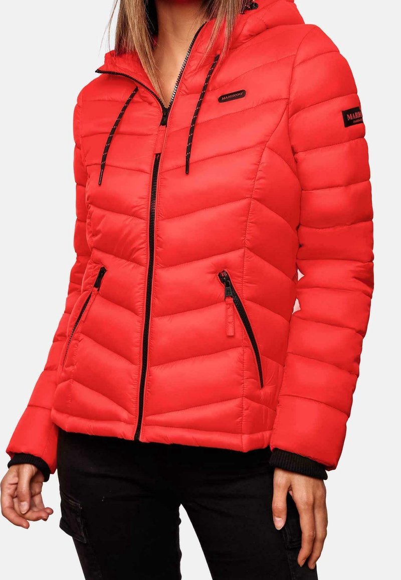 Doudoune rouge à capuche, dotée d'un design matelassé, avec des accents de fermeture éclair noirs et des poches latérales. Des poignets côtelés complètent le look.