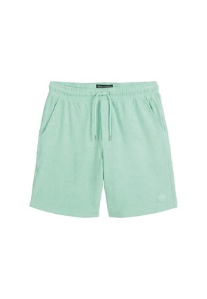 Mint green cotton shorts with an elastic waistband, drawstring, and two side pockets; features a small logo patch on the front.