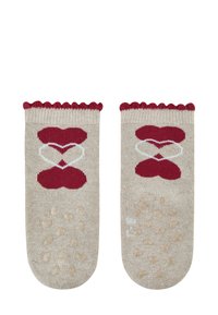 Beige Socken mit einem gewellten burgunderfarbenen Rand, versehen mit roten Herzmustern und strukturierten Grip-Punkten an der Sohle für Stabilität.