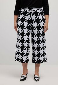 Zwart-witte houndstooth-gepatroneerde culottes met een elastische tailleband, voorzien van een trekkoord en metalen accenten. Korte wijde pasvorm.