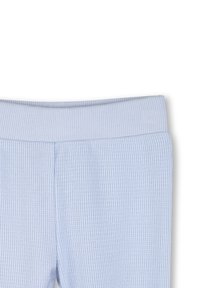 Leggings bleu clair côtelés avec une ceinture élastique, présentant un motif en tricot texturé sans éléments métalliques visibles ni accents.