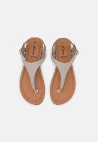 Flat sandals featuring a light gray textured upper strap, tan soft foam footbed, and decorative gold ring at the toe bridge. Size 37.
