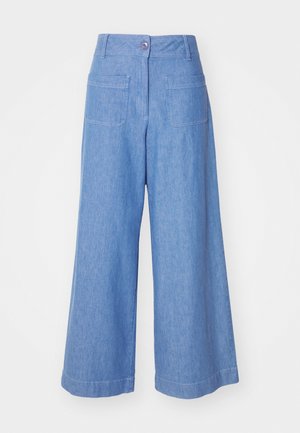 Wide-leg trousers in light blue denim. Features a high waist, front button closure, and two back pockets. Soft texture and casual design.