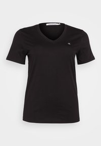 Černé tričko s výstřihem do V vyrobené z měkké bavlny. Krátké rukávy, slim fit, s malým logem CK na levé části hrudi.