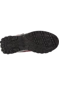 Black rubber outsole with multidirectional traction lugs, featuring hexagonal and circular patterns, complemented by a maroon upper.