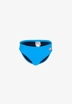 Bañador slip de hombre de color azul brillante con forro interior negro y etiqueta de talla visible en el interior de la cintura.