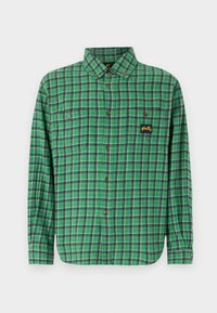Green plaid flannel shirt with long sleeves, featuring two buttoned chest pockets and a small yellow logo on the left pocket.