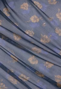 Blauw meshstof met beige bloemmotieven, met een gestructureerd oppervlak en gedrapeerde plooien die een gelaagde uitstraling creëren.