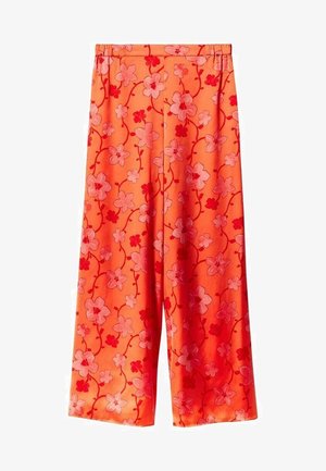 Pantalons larges orange vif avec une taille élastique et un motif floral rose et rouge sur l'ensemble.
