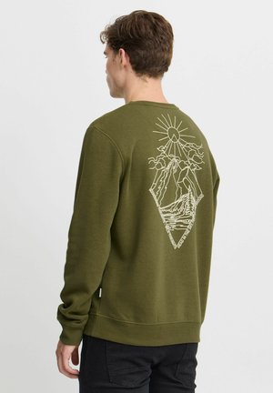 Olive green sweatshirt featuring a white outline design of mountains, sun, and clouds on the back; ribbed cuffs and hem.
