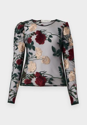 Blusa de manga larga transparente con bordado floral en burdeos y crema sobre un fondo gris. Presenta un escote redondo y detalle de hombros abullonados.