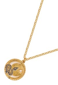 Gold necklace with a circular pendant featuring a snake design, crescent moon, star, and a pearl accent, all on a textured surface.