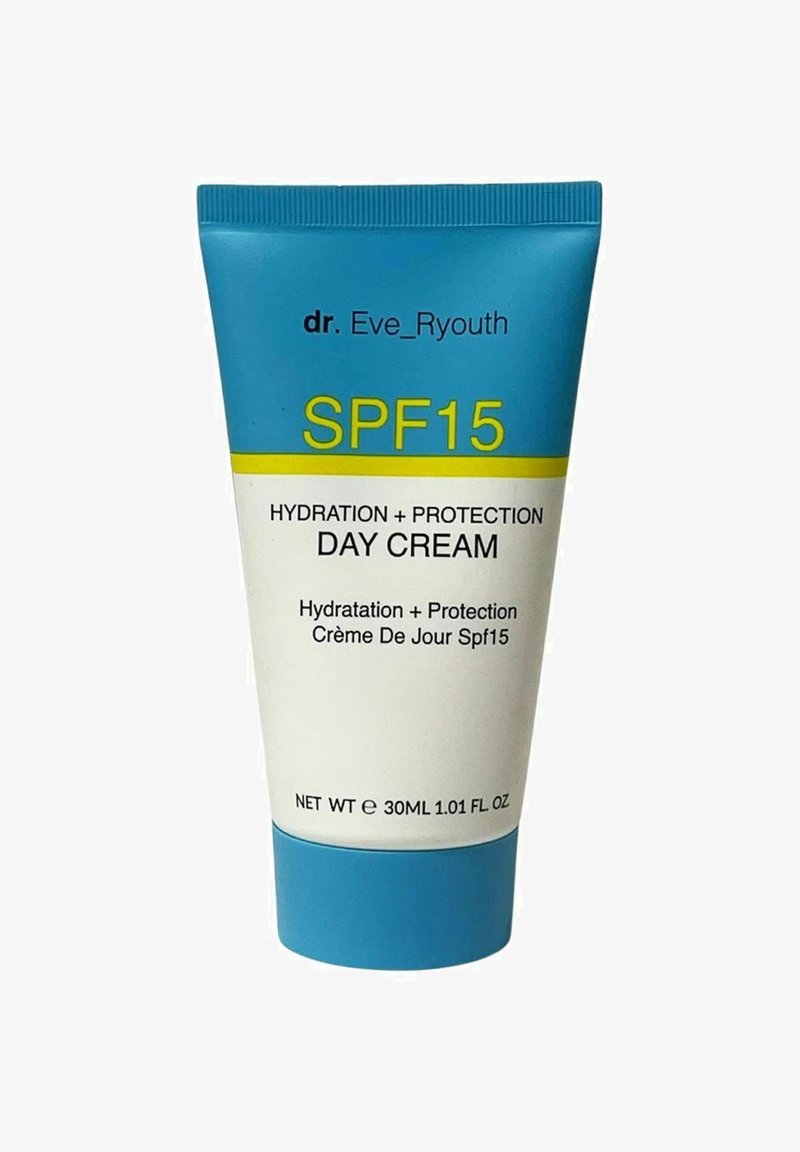 Biała tubka z turkusową nakrętką, oznaczona napisem 'KREM DZIENNY SPF15' w żółtym i czarnym kolorze, wskazującym na nawilżenie i ochronę. Rozmiar 30ML.