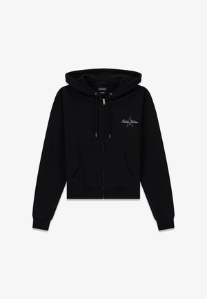 Black cropped hoodie made from soft material, featuring a front zipper, drawstring hood, and a star graphic with "Guess Jeans" text.