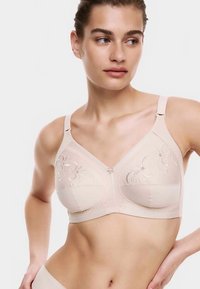 Béžová podprsenka s květinovou výšivkou, nastavitelnými ramínky a hladkou texturou. Má strukturovaný design a zapínání na háček a očko.