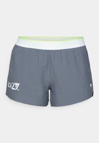 Gray athletic shorts with small perforations, white waistband with light green trim, and white "tcs 21 24" and New Balance logos.