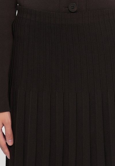 Dark brown pleated skirt made of textured fabric, featuring vertical stripes and a button detail at the waist for fastening.