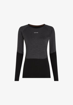 Long-sleeve women's dark gray and black fitted shirt with crew neckline and small white "icebreaker" logo on the chest.