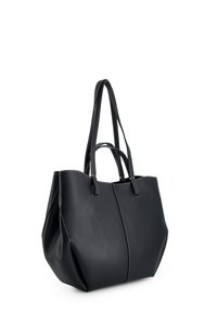 Black leather tote bag with two long handles, a textured finish, and contrasting white stitching, featuring a spacious interior and structured shape.