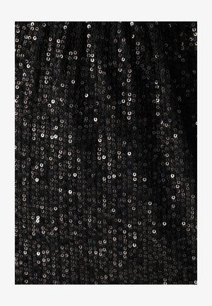 Black fabric covered in circular sequins, reflecting light with a shiny texture. The background appears soft and slightly sheer.