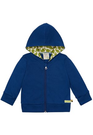 Felpa blu con zip e fodera verde a motivo, con piccoli balenotteri bianchi, maniche lunghe e polsini a costine. Etichetta visibile sul bordo inferiore.