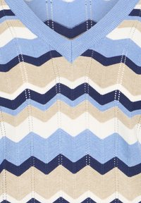 V-neck knitted sweater featuring a zigzag pattern in blue, beige, and white with textured ribbing and contrasting colors.