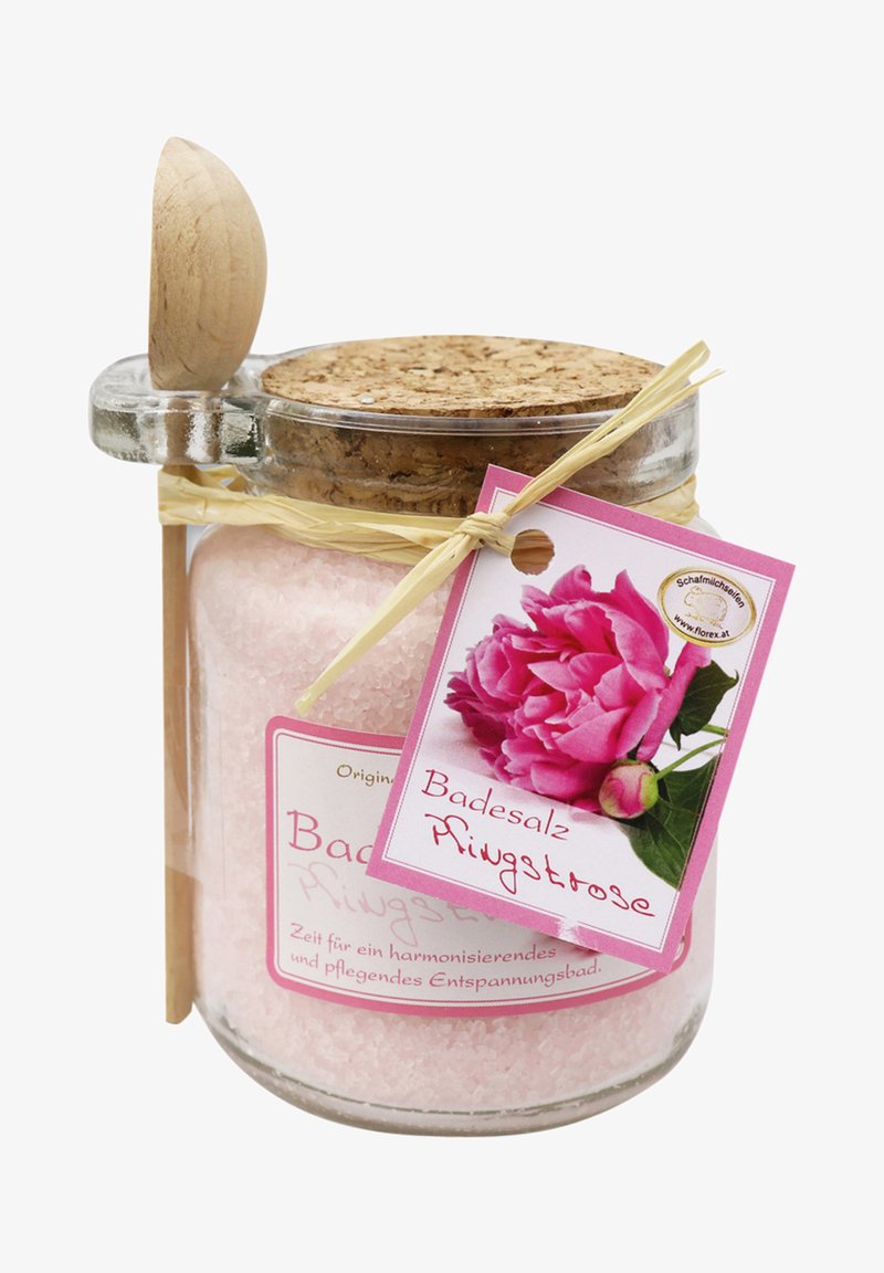 Glass jar with cork lid filled with pink bath salt, tied with straw, featuring a pink label with a peony flower image and product name.