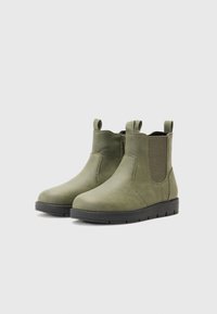 Botas de tobillo de cuero verde con paneles elásticos en los lados, punta redondeada, lengüetas y suelas de goma negras. Textura suave con un detalle mínimo.