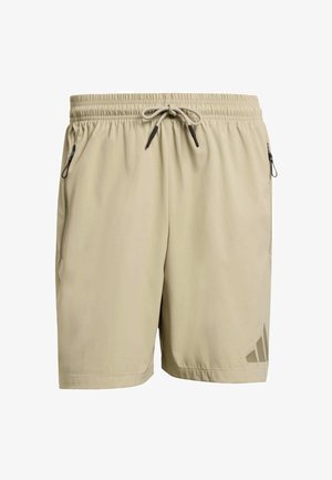 Beige atletiske shorts med elastisk talje, snøre og to sidelommer med lynlås. Har et diskret logo på venstre ben.